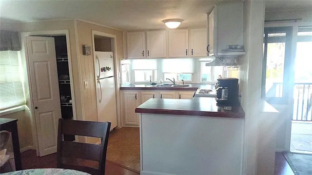 a kitchen with refrigerator and window