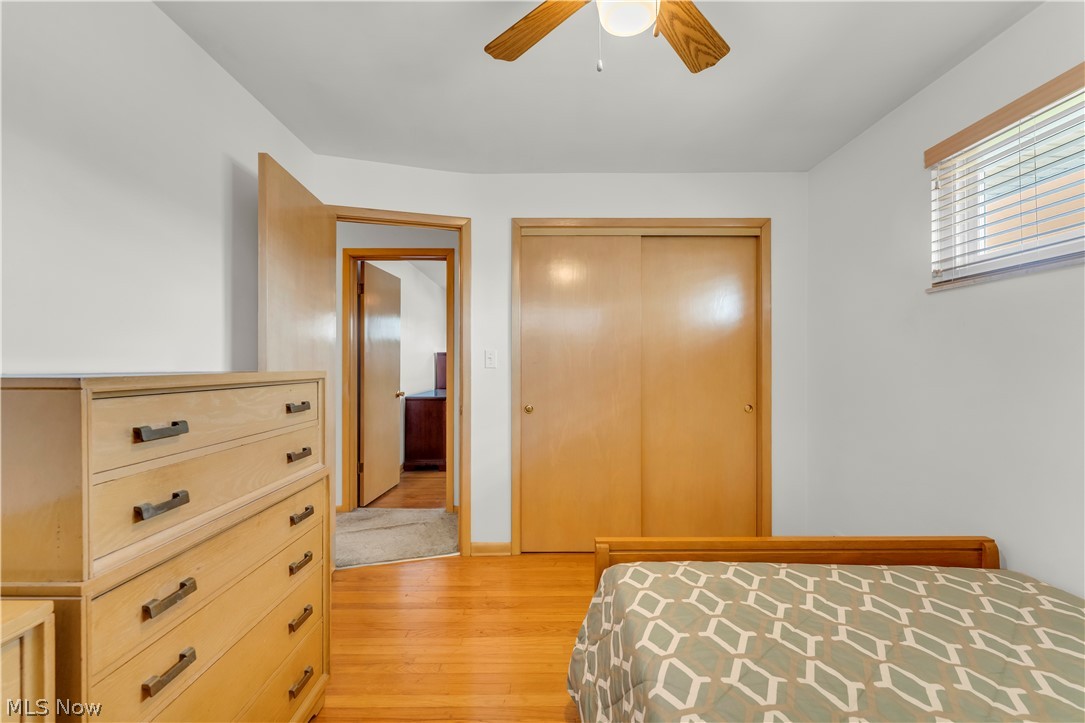 3023 Norris Avenue Cleveland, OH 44134 - Photo 19 of 41 Room with wood-finish flooring, a ceiling fan with light fixture, and a window with horizontal blinds