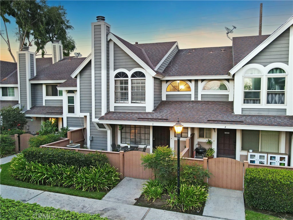 front view of a brick house with a yard