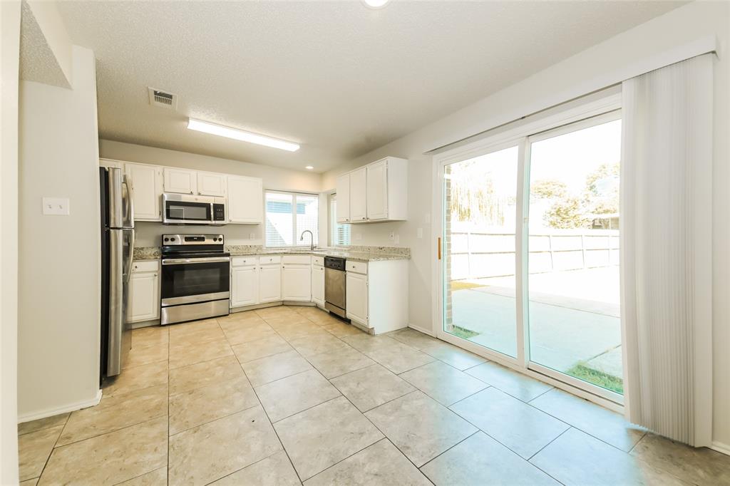 3511 Jasmine Lane Rowlett, TX 75089 - Photo 12 of 27 a kitchen with a sink stainless steel appliances and cabinets