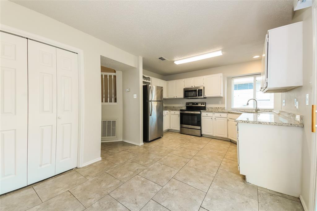 3511 Jasmine Lane Rowlett, TX 75089 - Photo 13 of 27 a kitchen with stainless steel appliances granite countertop a refrigerator and a stove top oven