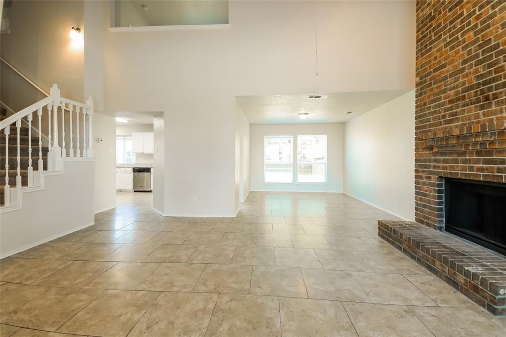 3511 Jasmine Lane Rowlett, TX 75089 - Photo 6 of 27 a view of an empty room with a fireplace and a window