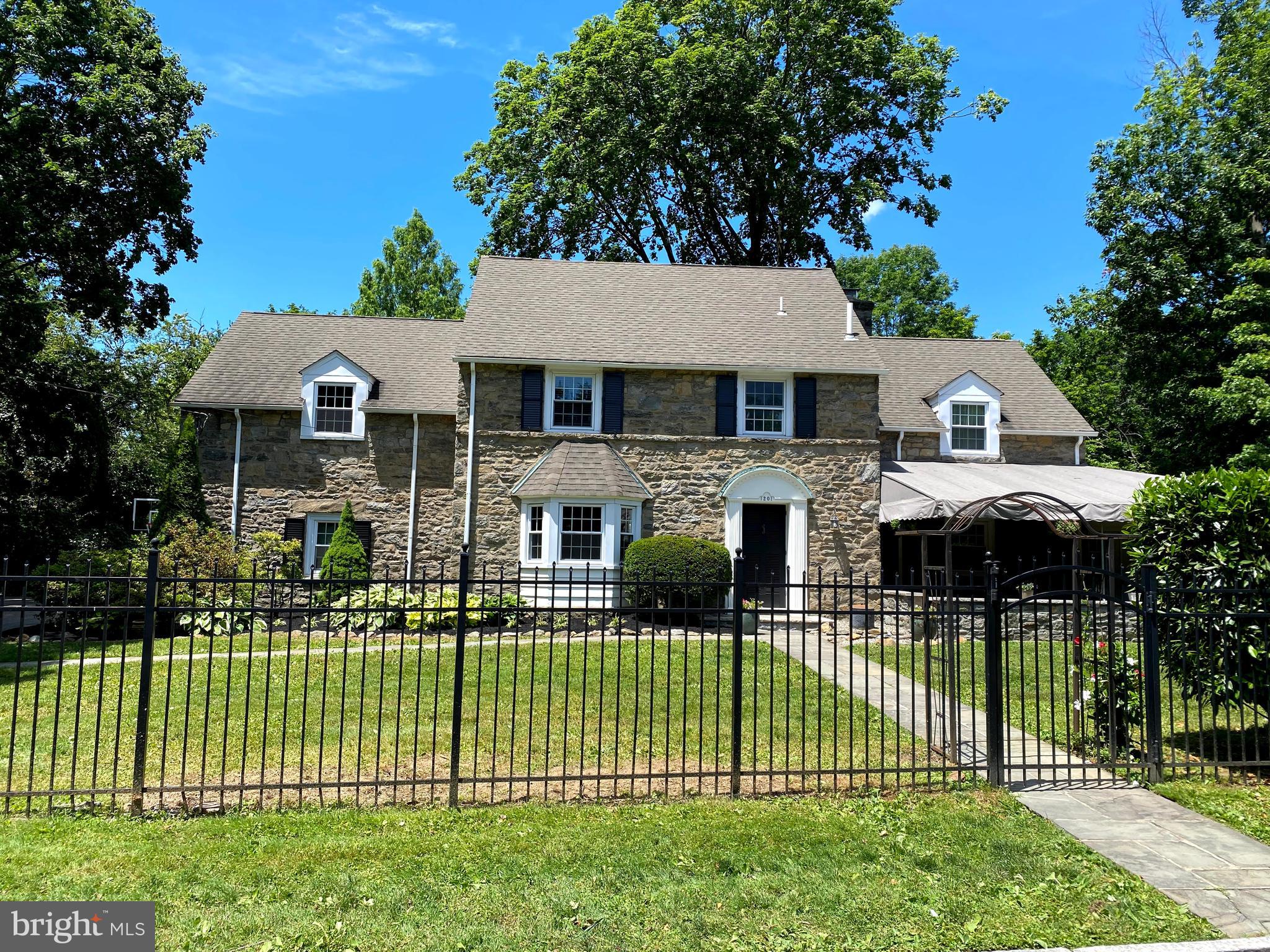 1201 Knox Road Wynnewood, PA 19096 - Photo 1 of 49 a front view of a house with a garden