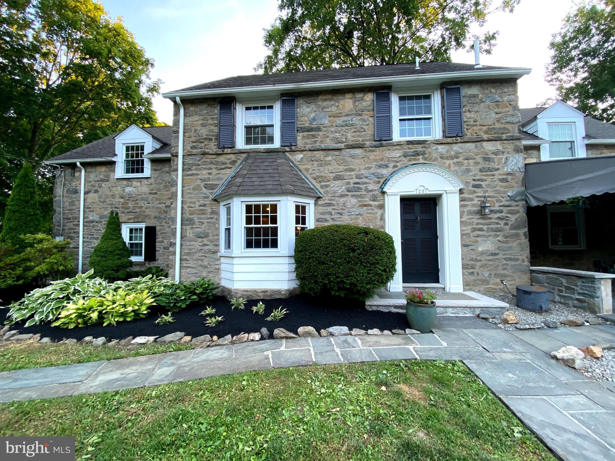1201 Knox Road Wynnewood, PA 19096 - Photo 2 of 49 a front view of a house with a yard and porch