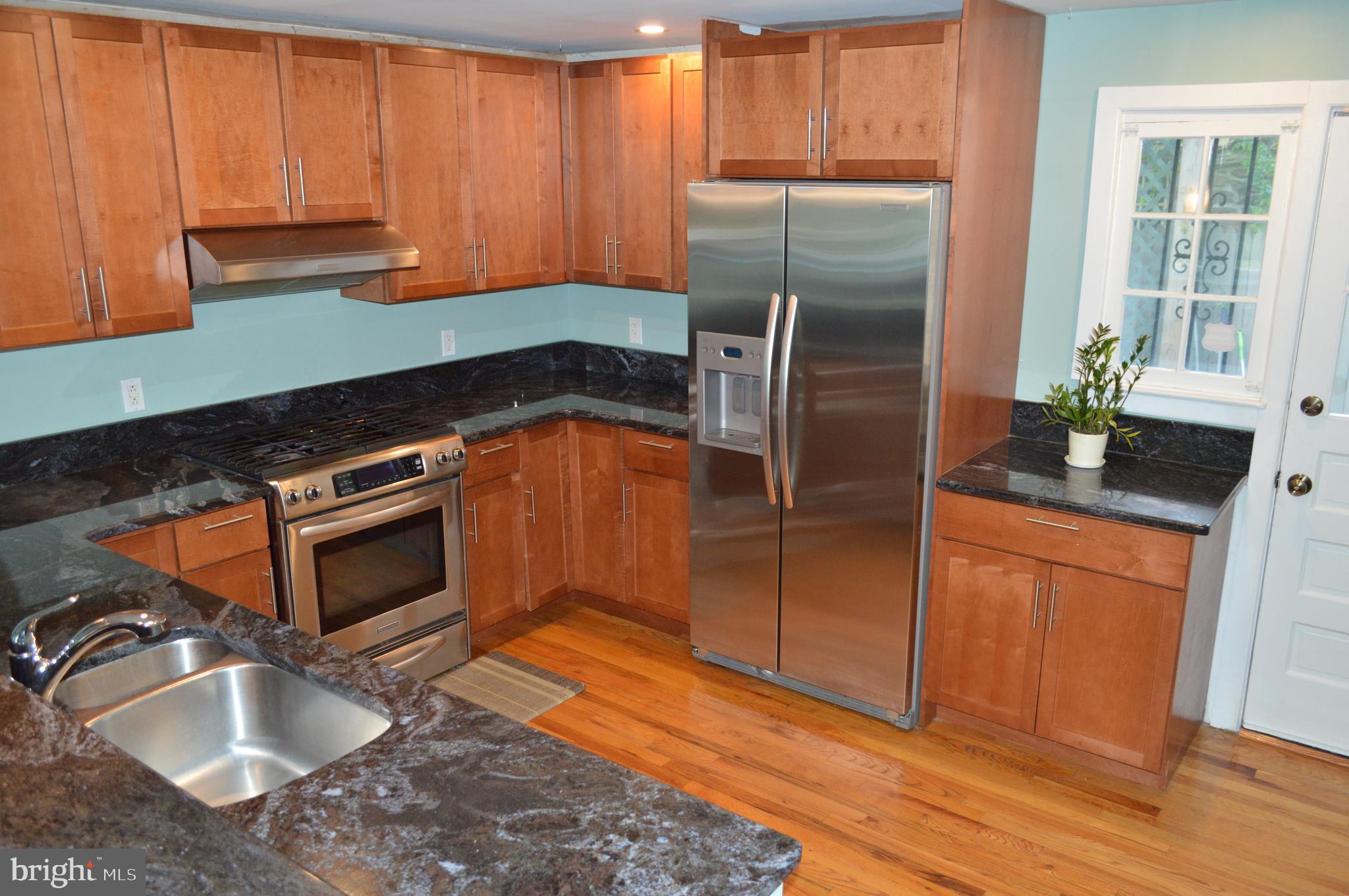 1201 Knox Road Wynnewood, PA 19096 - Photo 21 of 49 a kitchen with granite countertop stainless steel appliances a stove a refrigerator a sink and dishwasher