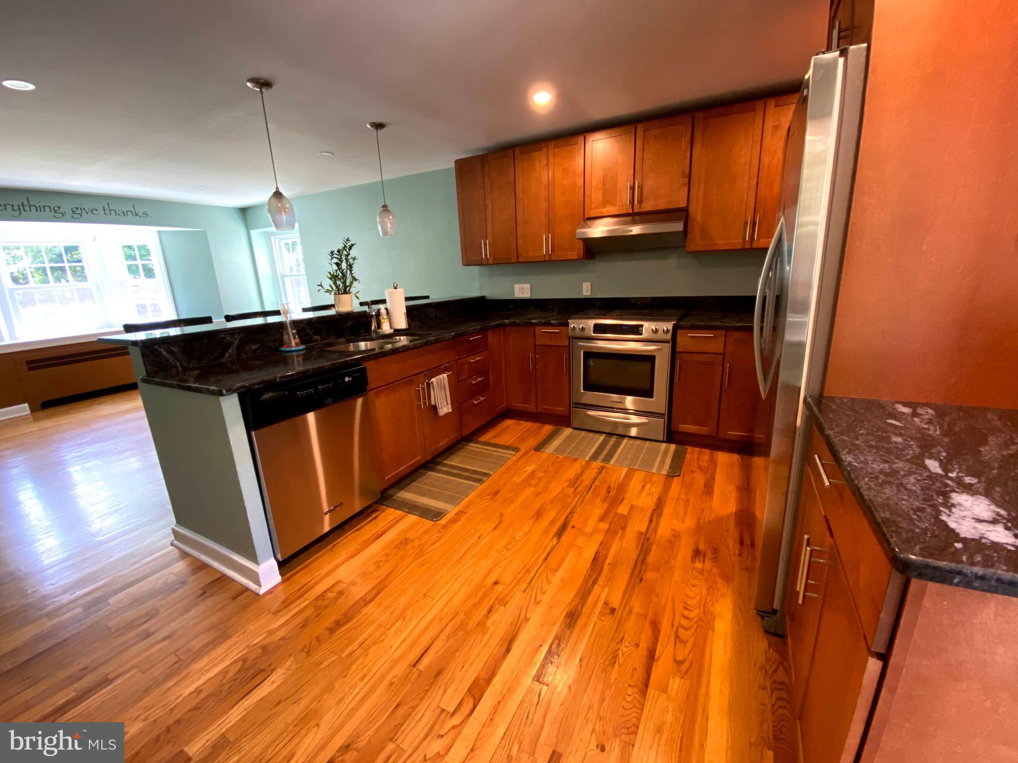 1201 Knox Road Wynnewood, PA 19096 - Photo 22 of 49 a kitchen with stainless steel appliances granite countertop a stove a sink and a microwave