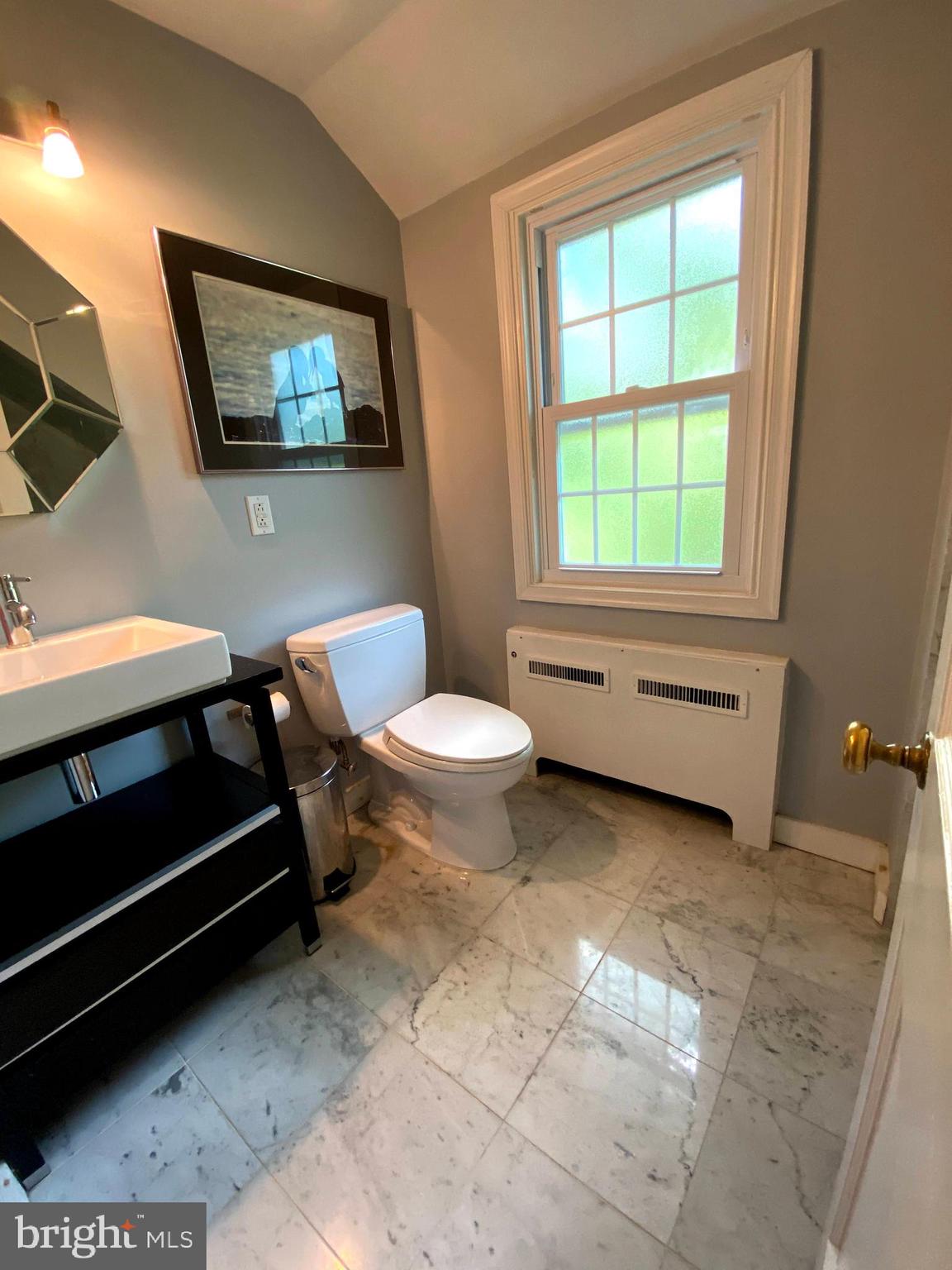 1201 Knox Road Wynnewood, PA 19096 - Photo 31 of 49 a bathroom with a sink a toilet and a window