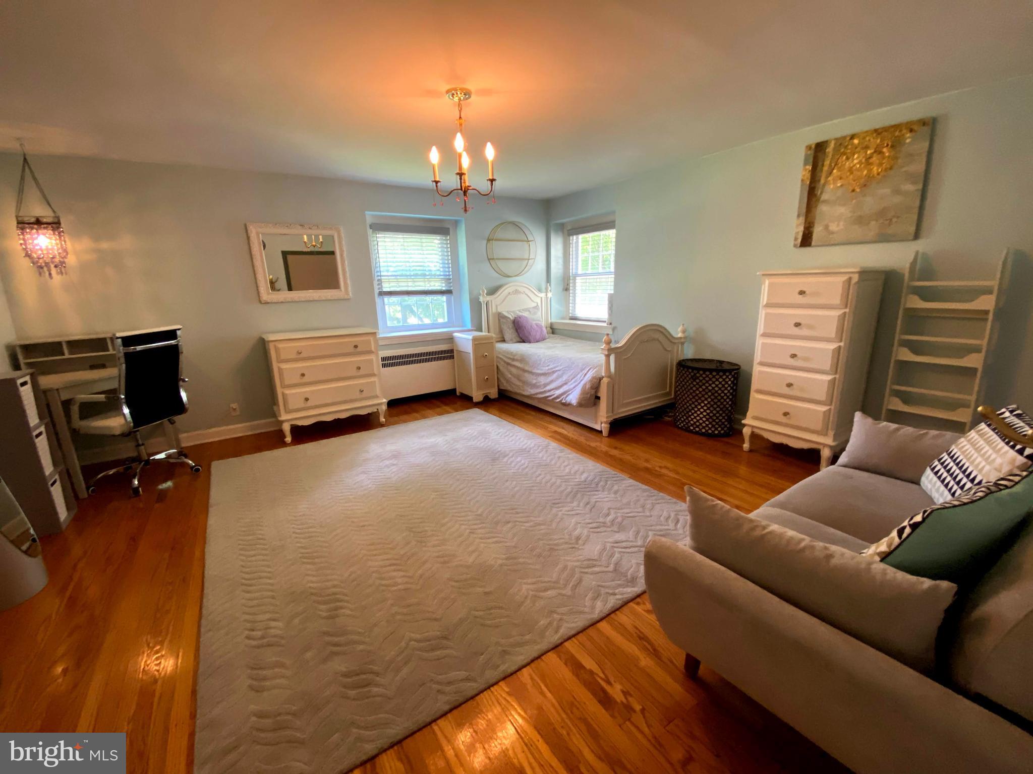 1201 Knox Road Wynnewood, PA 19096 - Photo 34 of 49 a bedroom with furniture and a lamp