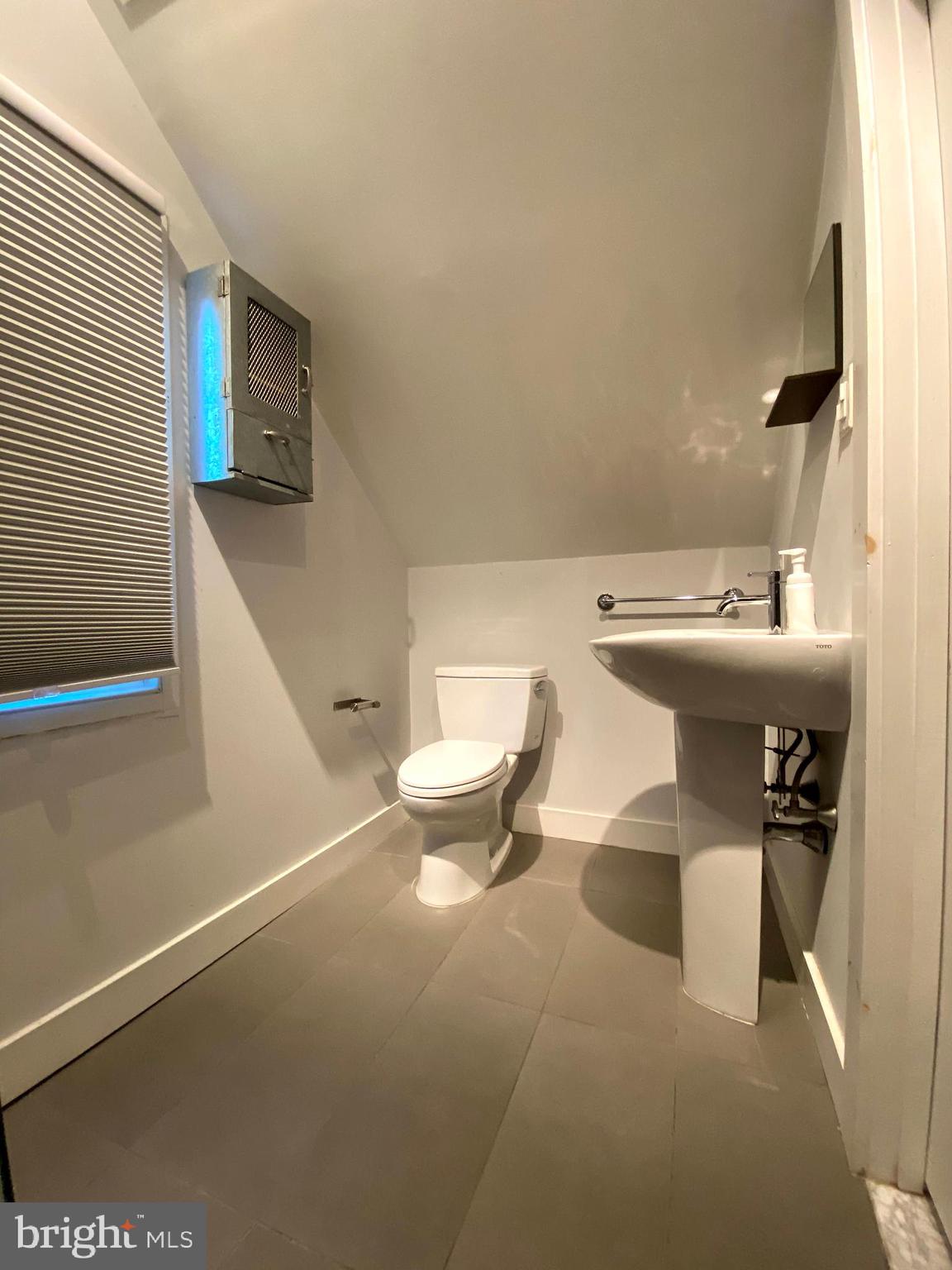 1201 Knox Road Wynnewood, PA 19096 - Photo 41 of 49 a bathroom with a toilet a sink and mirror