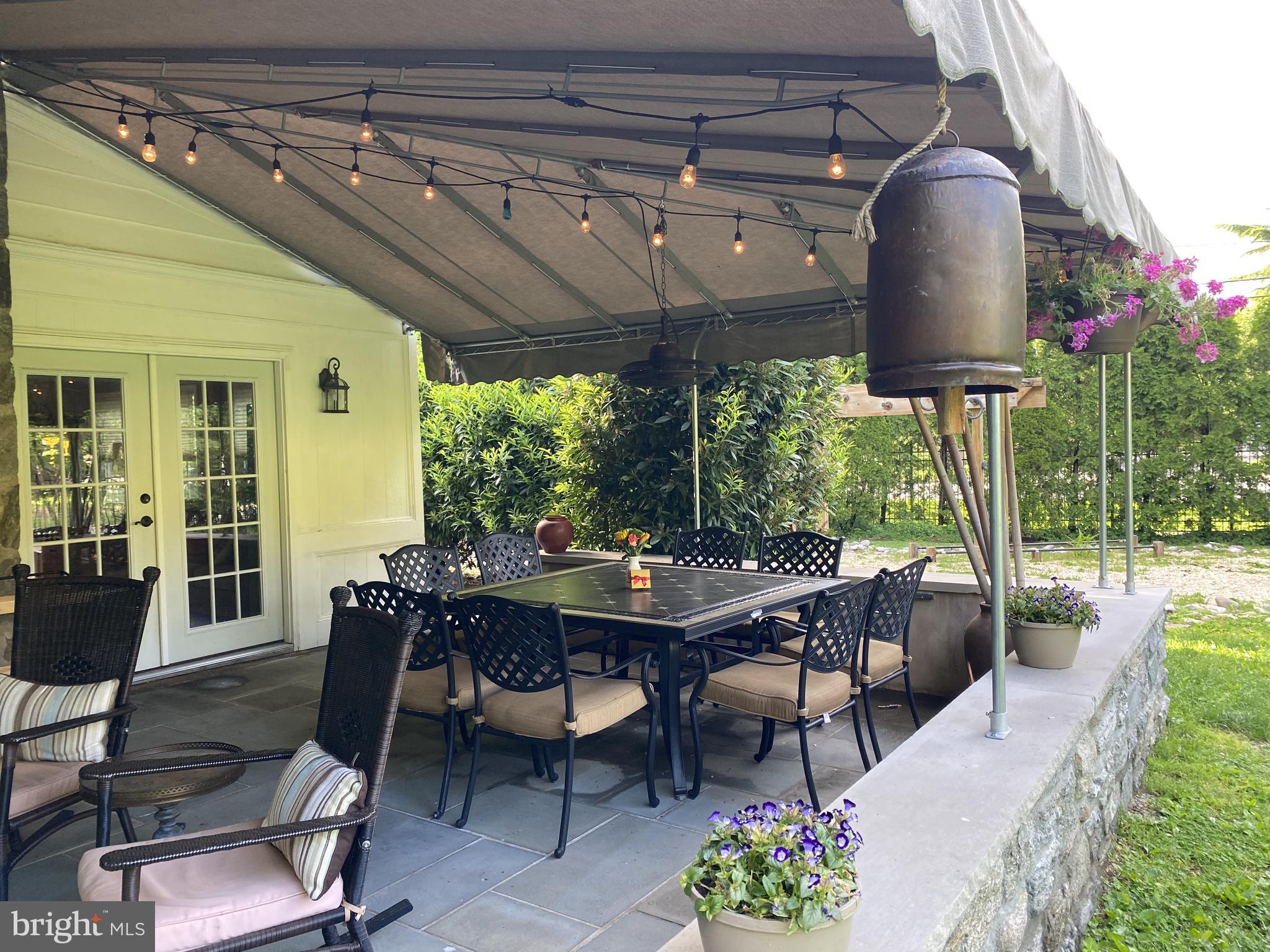 1201 Knox Road Wynnewood, PA 19096 - Photo 9 of 49 a outdoor dining space with furniture and garden view