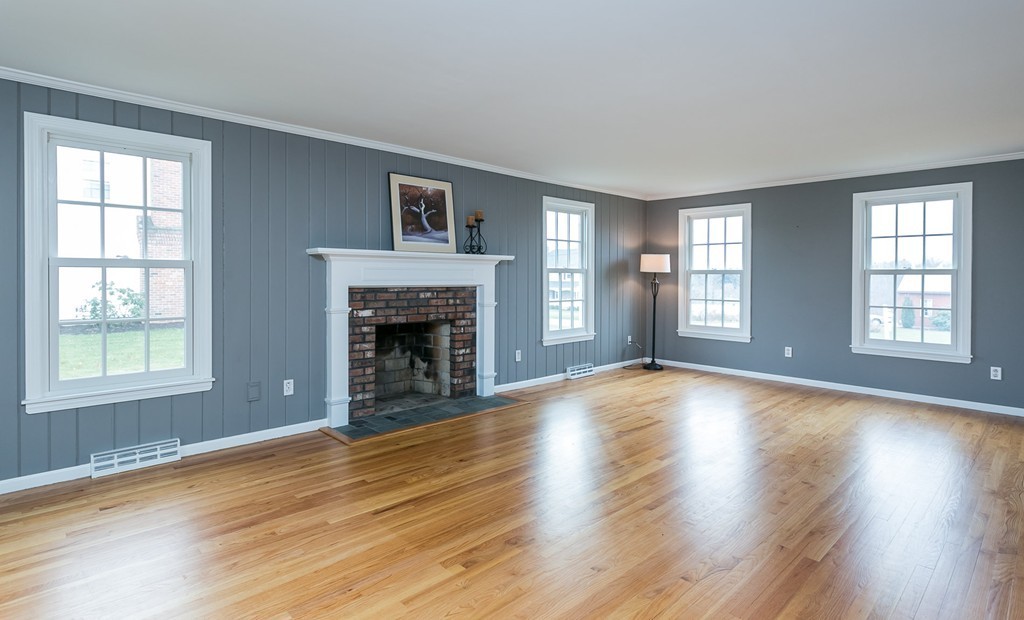 33 West Colonial Road Wilbraham, MA 01095 - Photo 9 of 23 a view of empty room with wooden floor and fireplace