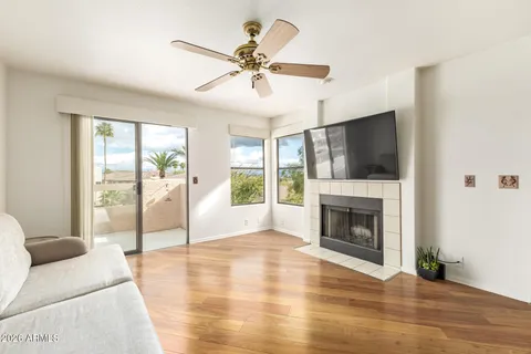 a living room with fireplace furniture and a flat screen tv
