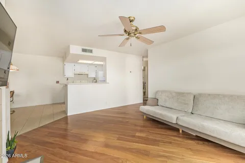 a living room with furniture and a wooden floor