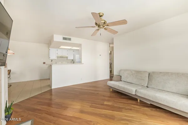 a living room with furniture and a wooden floor