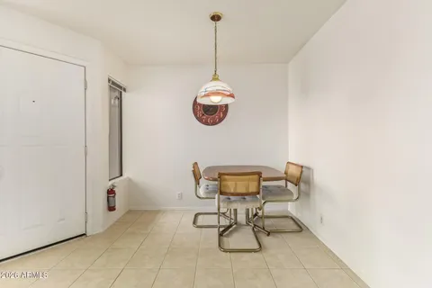 a dining room with a window and chairs