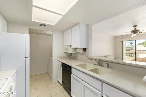 a kitchen with a sink cabinets and window