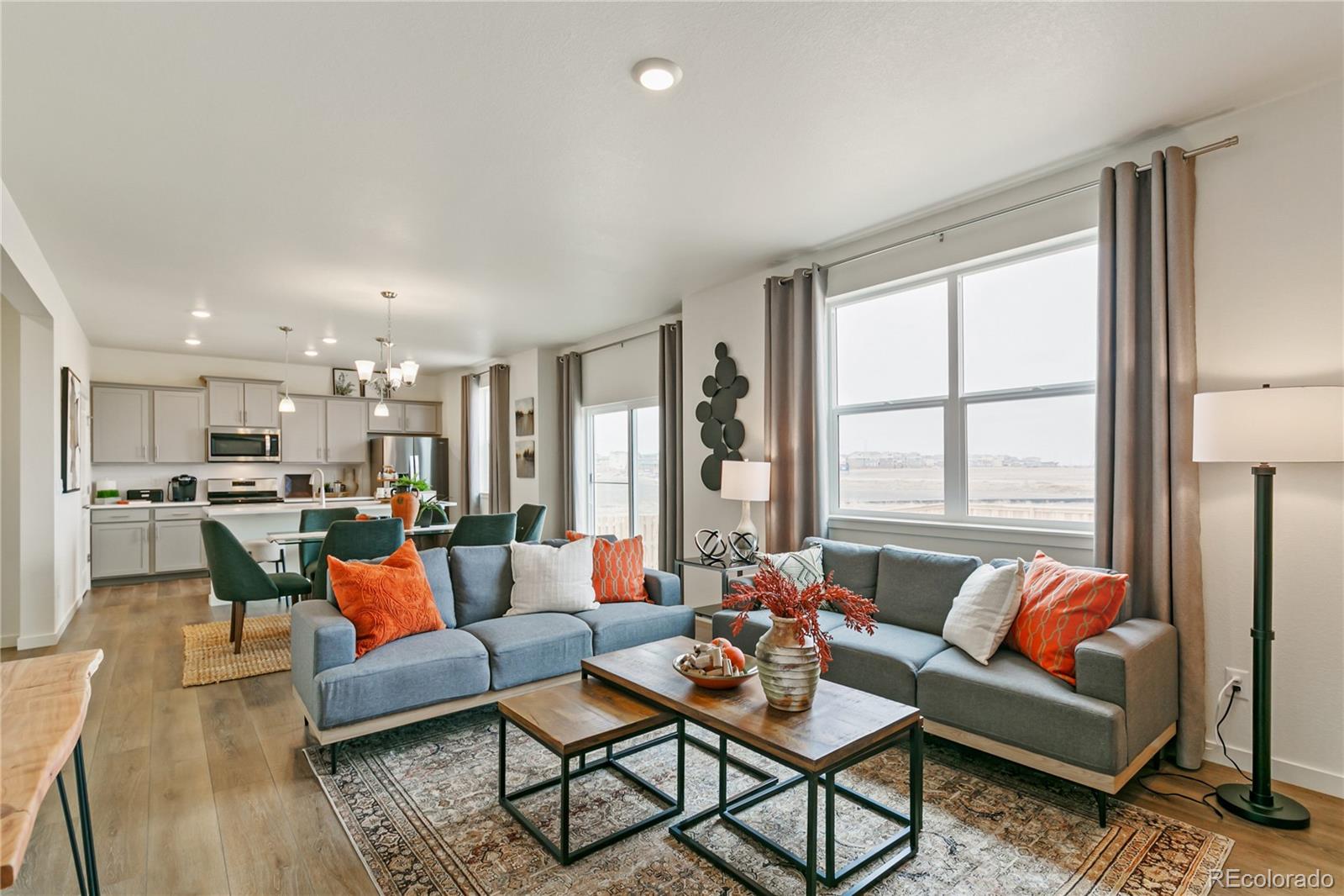 2236 Crosswind Street Fort Lupton, CO 80621 - Photo 3 of 32 a living room with furniture and a large window