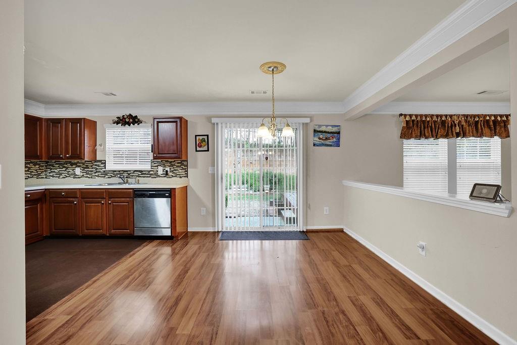 3160 Centerglen Lane Cumming, GA 30040 - Photo 12 of 40 a kitchen with stainless steel appliances a stove a refrigerator wooden floor and a large window
