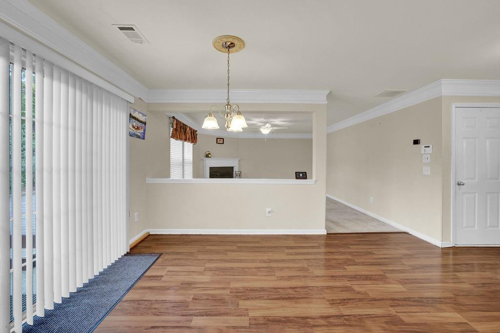3160 Centerglen Lane Cumming, GA 30040 - Photo 16 of 40 a view of a room with wooden floor chandelier and entryway