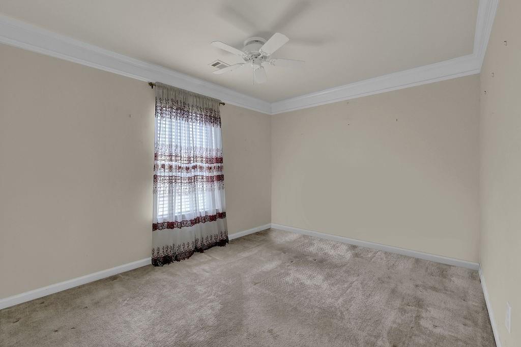 3160 Centerglen Lane Cumming, GA 30040 - Photo 22 of 40 an empty room with windows and ceiling fan