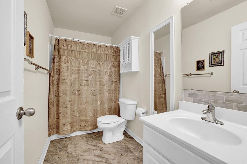 3160 Centerglen Lane Cumming, GA 30040 - Photo 24 of 40 a bathroom with a sink toilet and shower