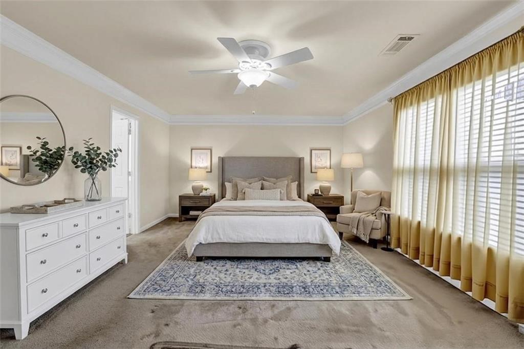 3160 Centerglen Lane Cumming, GA 30040 - Photo 30 of 40 a bedroom with a large bed and a chandelier
