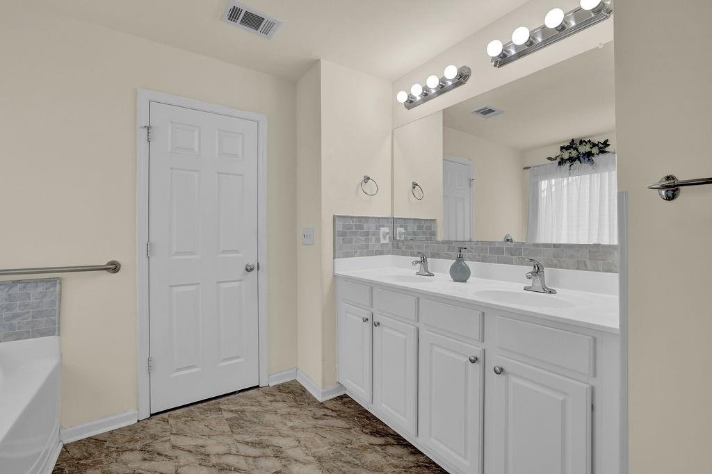 3160 Centerglen Lane Cumming, GA 30040 - Photo 33 of 40 a bathroom with a sink double vanity and a mirror