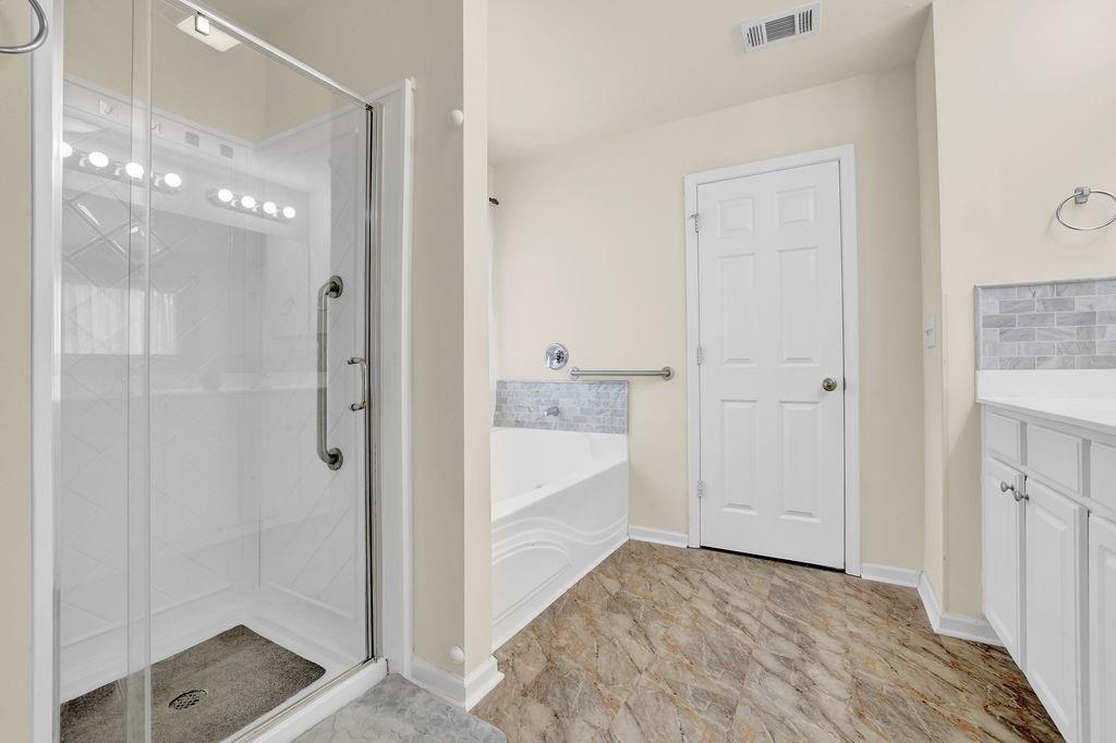 3160 Centerglen Lane Cumming, GA 30040 - Photo 34 of 40 a bathroom with a shower and a tub
