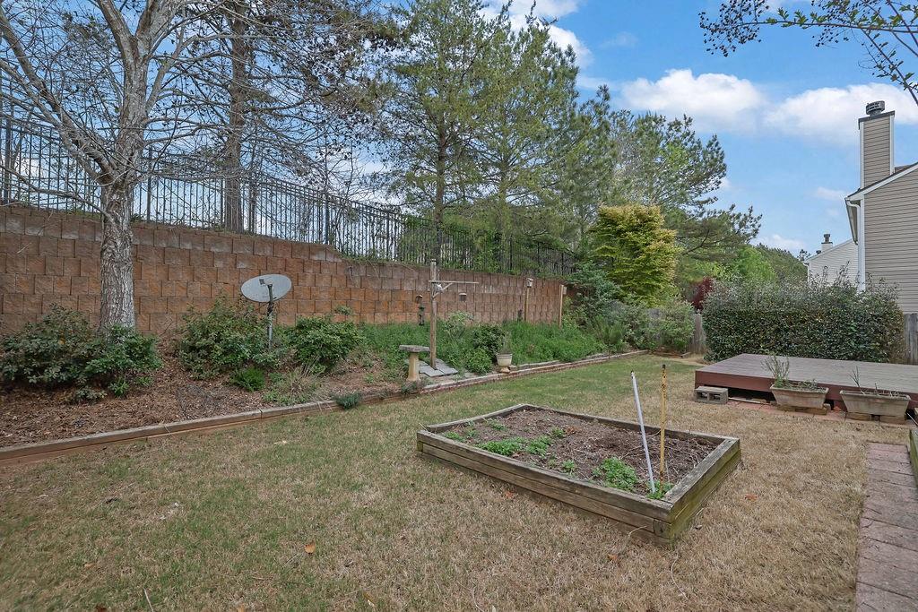 3160 Centerglen Lane Cumming, GA 30040 - Photo 36 of 40 a backyard of a house with fountain table and chairs