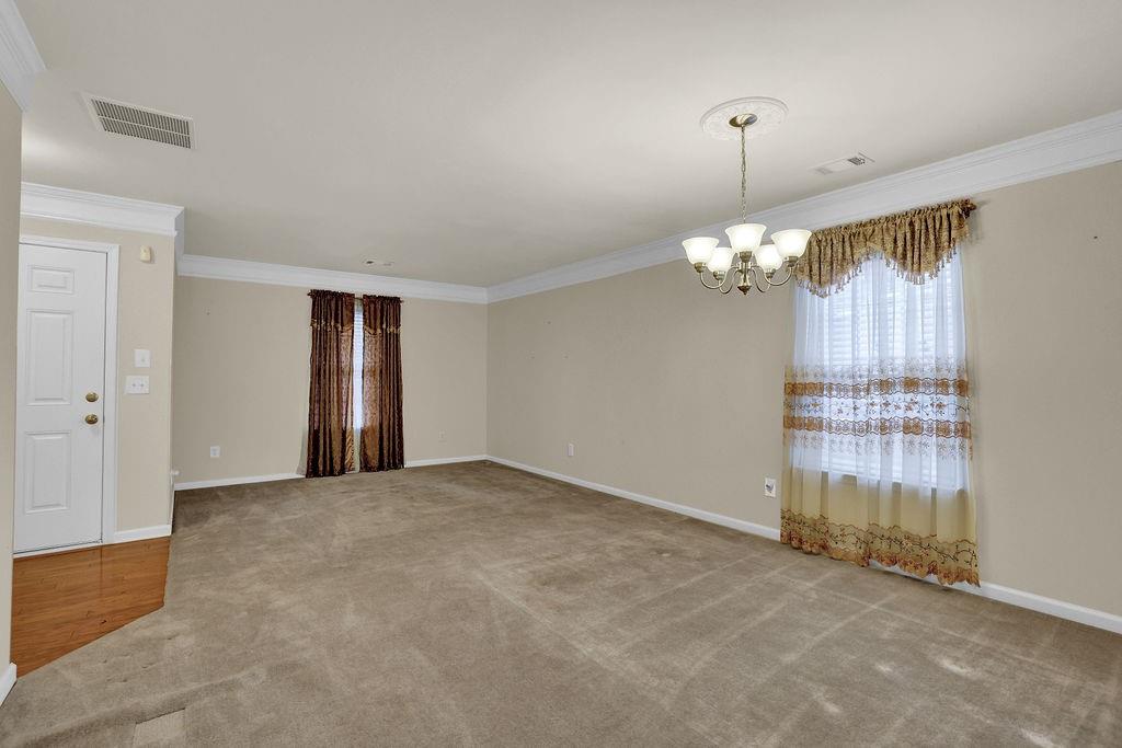 3160 Centerglen Lane Cumming, GA 30040 - Photo 10 of 40 an empty room with chandelier fan and windows