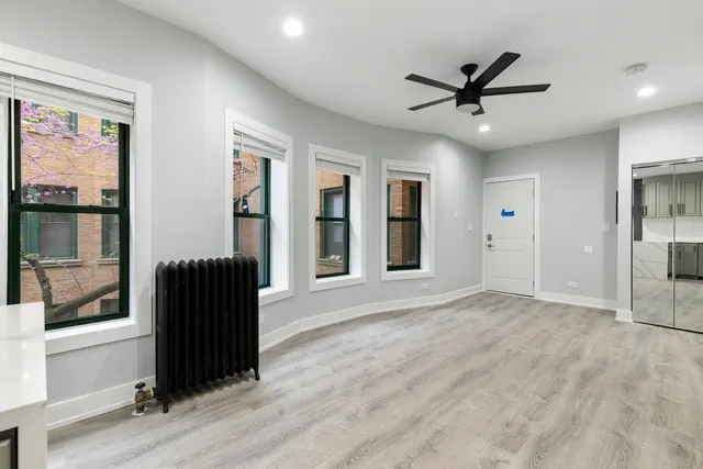 a view of a livingroom with a window and wooden floor