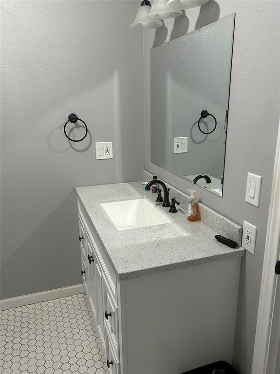 401 South Ave H Olney, TX 76374 - Photo 11 of 22 a bathroom with a sink a vanity and a mirror