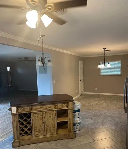 a kitchen with a table and chandelier