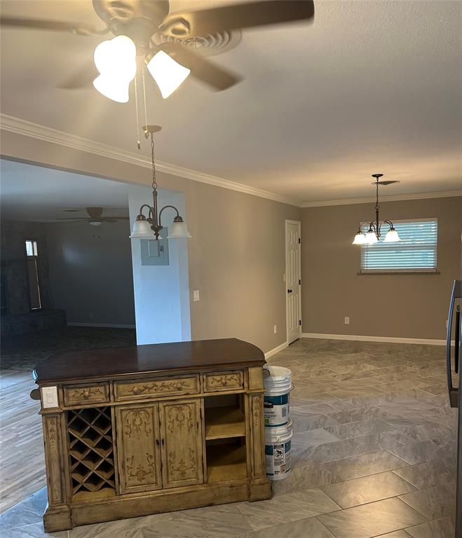 401 South Ave H Olney, TX 76374 - Photo 8 of 22 a kitchen with a table and chandelier