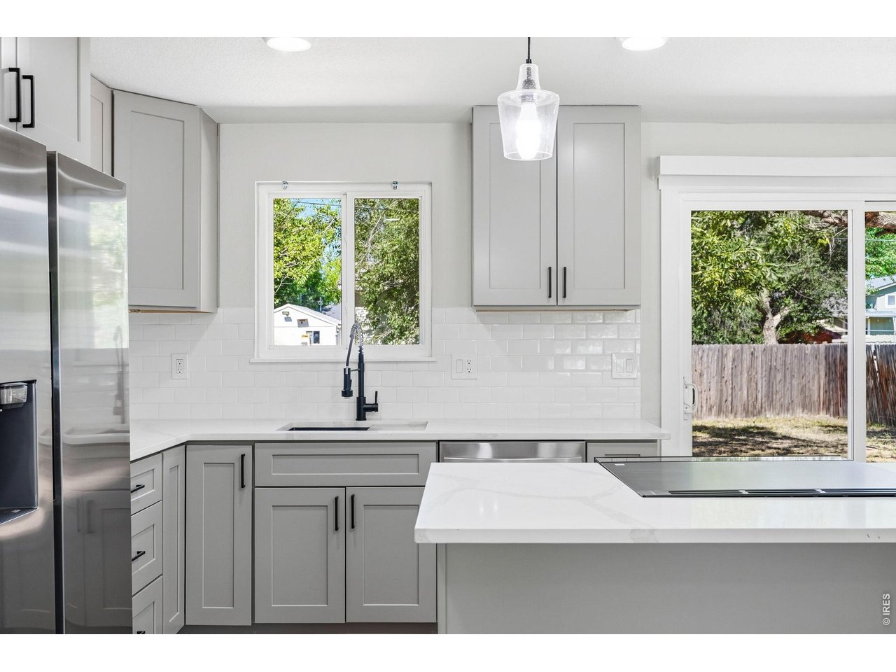 1035 6th Street Berthoud, CO 80513 - Photo 11 of 37 a kitchen with a sink cabinets and window