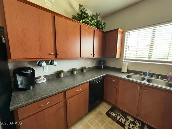 a kitchen with a sink stove top oven and cabinets