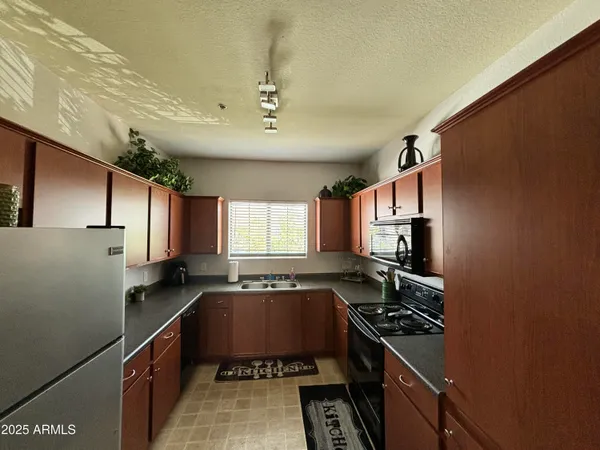 a kitchen with stainless steel appliances granite countertop a sink stove and microwave