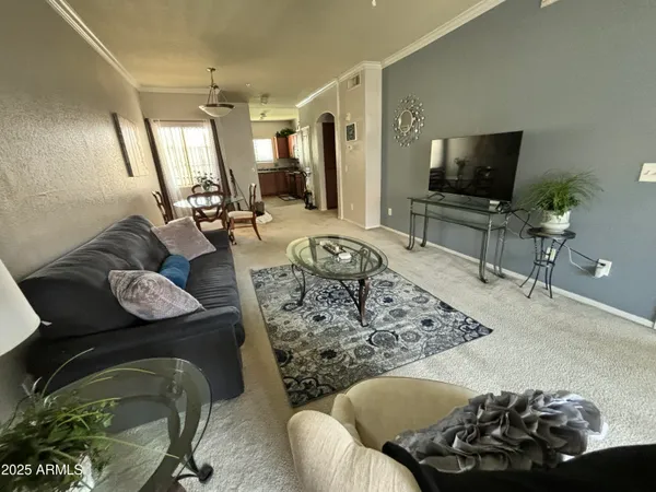 a living room with furniture and a flat screen tv