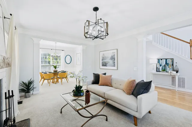 a living room with furniture and a chandelier