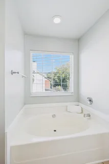 a bathroom with a bathtub and window