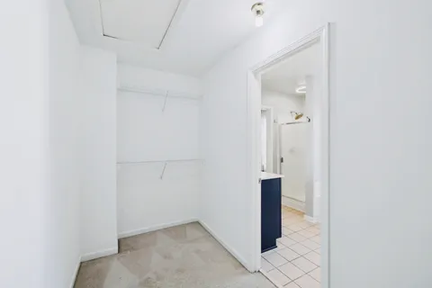 a view of an empty room and a ceiling fan