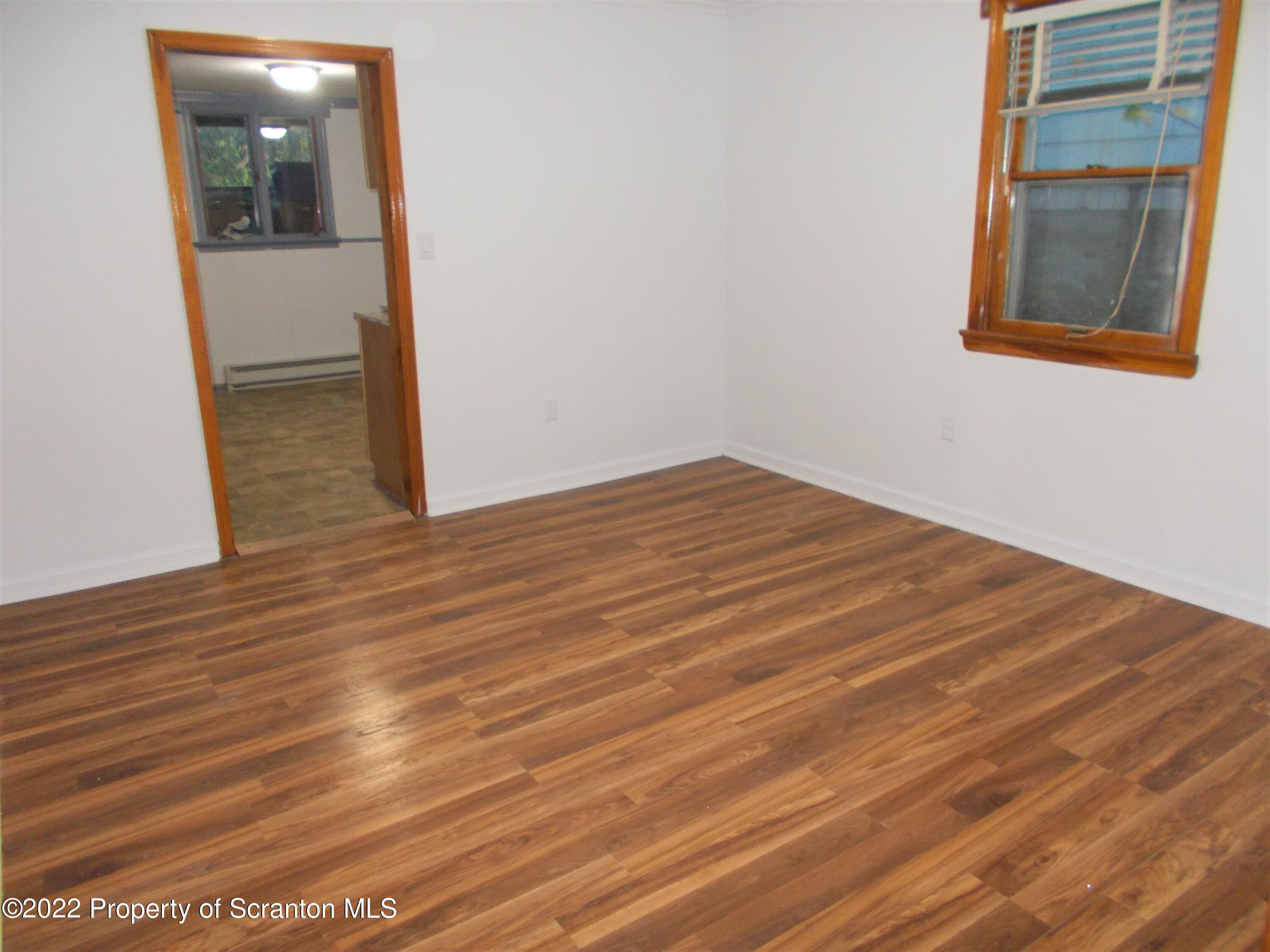 909 Slocum Avenue, Unit 1B Scranton, PA 18505 - Photo 4 of 9 a view of empty room with wooden floor