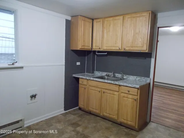 a kitchen with a sink and cabinets
