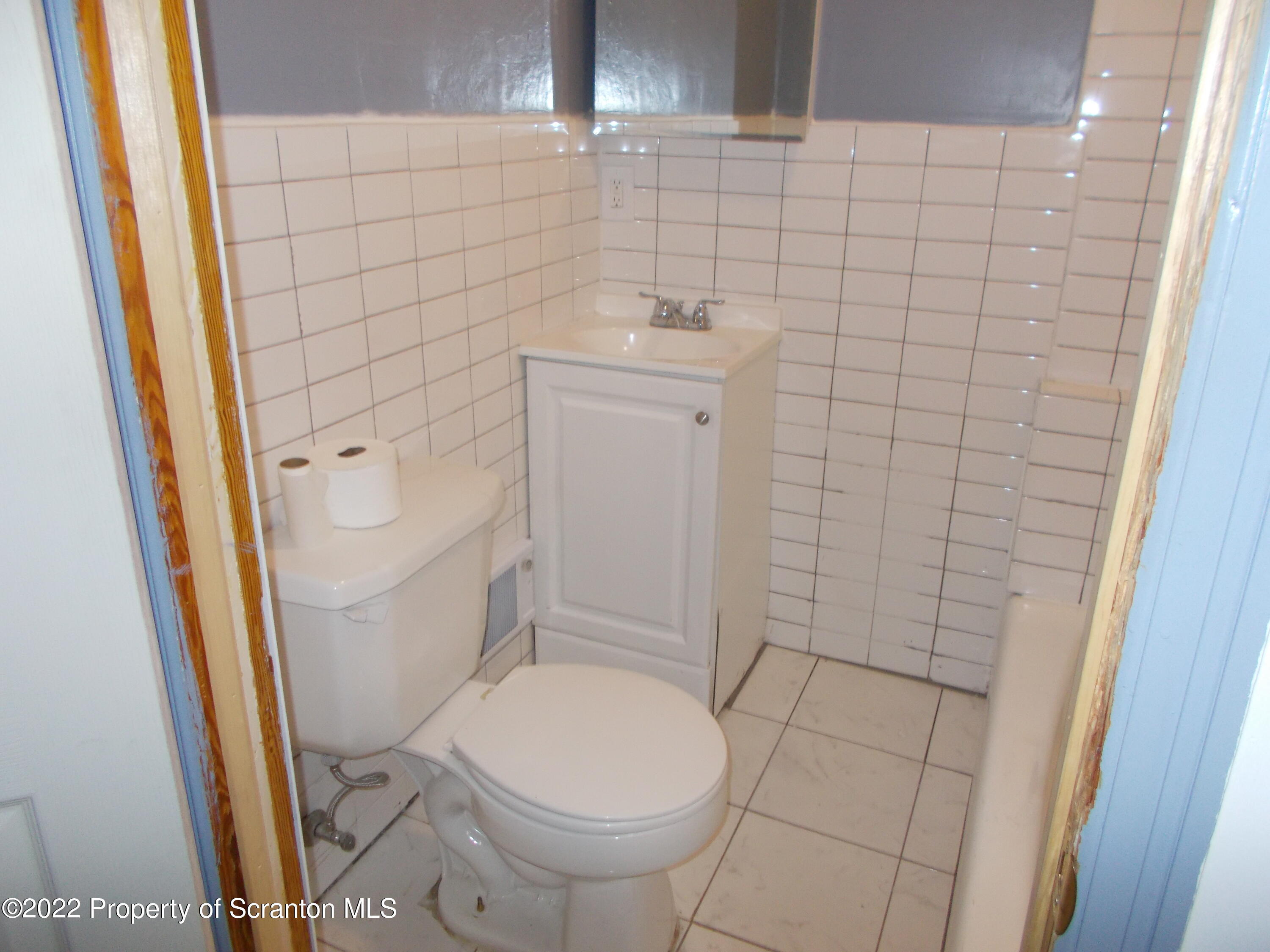 909 Slocum Avenue, Unit 1B Scranton, PA 18505 - Photo 9 of 9 a bathroom with a sink and toilet