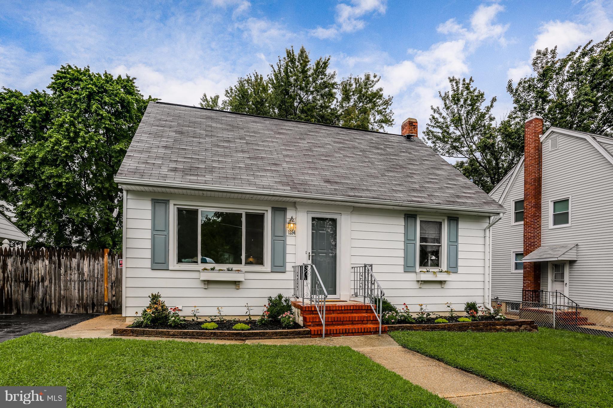 1254 June Road Baltimore, MD 21227 - Photo 1 of 23 a front view of house with yard and green space