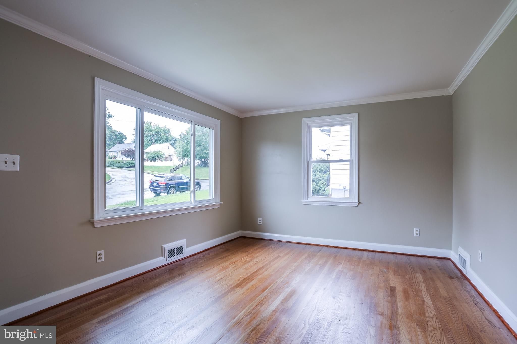 1254 June Road Baltimore, MD 21227 - Photo 3 of 23 a view of an empty room with wooden floor and a window