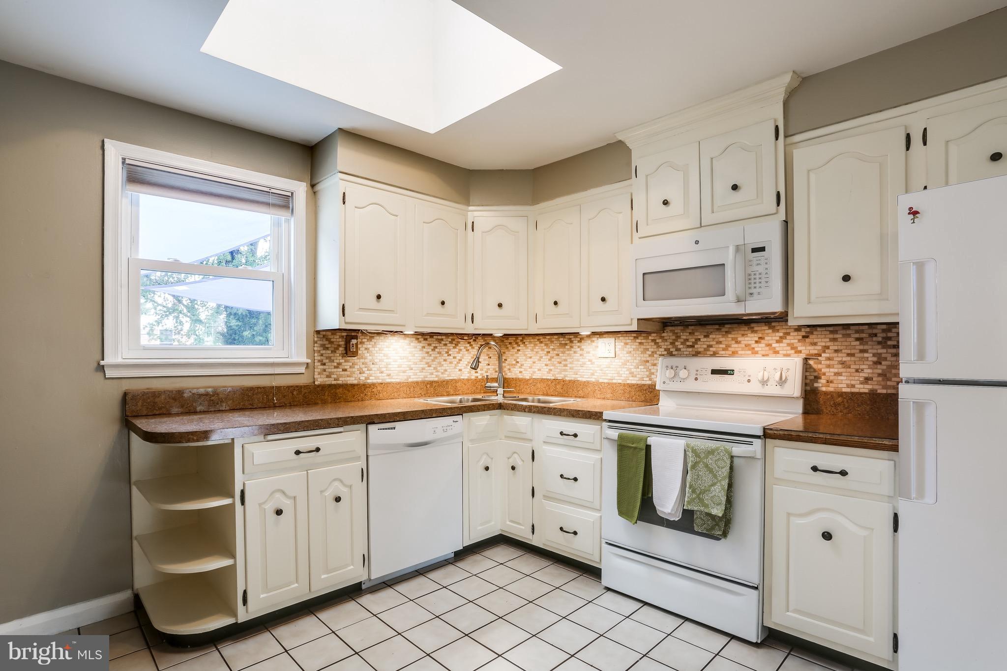 1254 June Road Baltimore, MD 21227 - Photo 4 of 23 a kitchen with white cabinets and white appliances