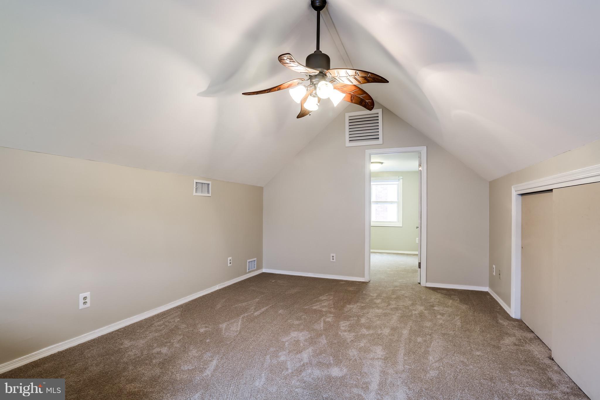 1254 June Road Baltimore, MD 21227 - Photo 5 of 23 a view of a chandelier fan and window in an empty room