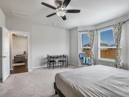 a bedroom with a bed and a large window