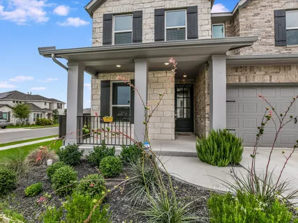 a view of a house with potted plants
